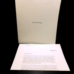 May include: A white letter with the text "Steuben Glass" at the top and a letter addressed to "Dear Steuben Friend" at the bottom. The letter discusses an upcoming exhibition of Steuben glassware.
