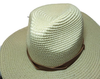 May include: A light beige straw hat with a brown leather band. The hat has a wide brim and a slightly indented crown.