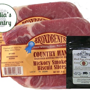 May include: An image of three packages of Broadbent's Country Ham Hickory Smoke Biscuit Slices, with a packet of Red Eye Gravy mix. The ham is dry-cured and ready to eat. The packaging includes the Julia's Pantry logo.