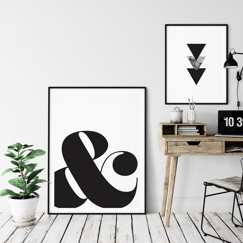 May include: Black and white printable wall art featuring a large ampersand symbol in a modern, bold font. The ampersand is centered on a white background with a black frame.