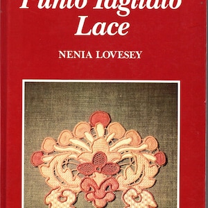 May include: A book cover with the title "Punto Tagliato Lace" in white text on a red background. The author's name, Nenia Lovesey, is below the title. The cover features a detailed, colorful lace design in shades of peach, coral, and cream.