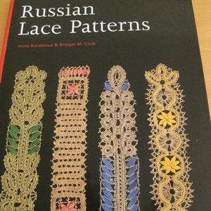 May include: Book cover for "Russian Lace Patterns" by Anna Korableva & Bridget M. Cook. The cover features four different lace patterns in shades of green, pink, blue, and yellow on a black background.