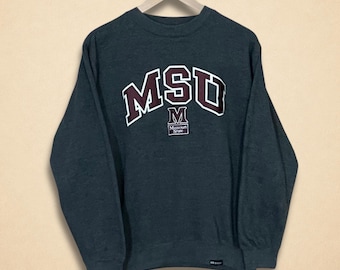 May include: Dark gray sweatshirt with the letters "MSU" in maroon and white lettering across the chest. Below the letters is a small maroon and white logo with the letter "M" and the words "Missouri State". The sweatshirt is hanging on a wooden hanger.
