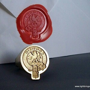 May include: A gold ring with a red wax seal impression. The seal features a crest with a bird and the text "CONSILIO".