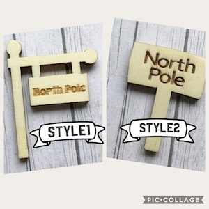 Puede incluir: Dos letreros de madera de Polo Norte, uno con un diseño tradicional de poste indicador y el otro con un letrero rectangular simple. Los letreros están etiquetados como "STYLE1" y "STYLE2".