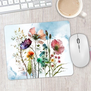 May include: A watercolor painting of a bouquet of wildflowers with pink, purple, orange, and blue flowers on a blue and white background.