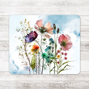 May include: A watercolor painting of a bouquet of colorful wildflowers against a blue sky background. The flowers include pink, purple, orange, and blue blooms.