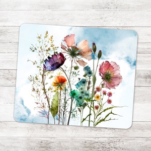 May include: A watercolor painting of a bouquet of colorful wildflowers against a blue sky background. The flowers include pink, purple, orange, and blue blooms.