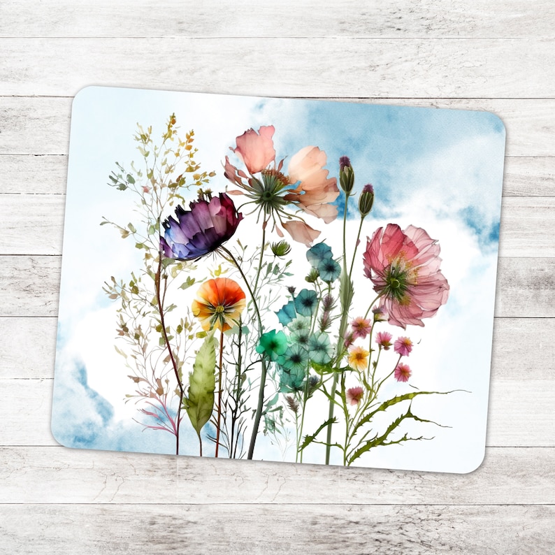 May include: A watercolor painting of a bouquet of colorful wildflowers against a blue sky background. The flowers include pink, purple, orange, and blue blooms.