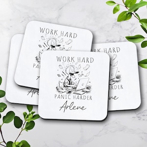 May include: Set of four white coasters with black text and a cartoon duck illustration. The text reads "Work Hard Panic Harder" and is personalized with the name "Arlene".