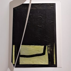 May include: Abstract painting with a black background and a green and black foreground. The painting is framed in a white mat.