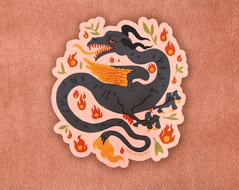 May include: A black and orange sticker featuring a stylized dragon with flames and leaves. The dragon has a long tail and wings. The text "ViolentCosmos" is at the bottom of the sticker.