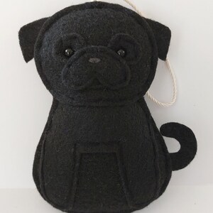 May include: Black felt pug dog ornament with a string loop for hanging.