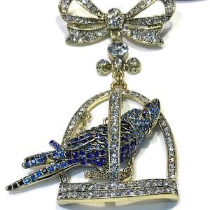 Beautiful Large Heidi Daus Clear, Shades of Blue, Black Cockatiel in a Bird Cage  Bow Dangle Brooch