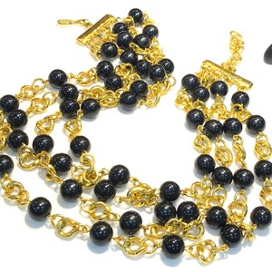 Vintage Monet Four Strand Black Lucite Bead Necklace