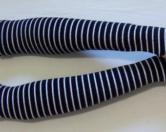 May include: A pair of black and white striped fingerless gloves. The gloves are made of a soft, stretchy fabric and are perfect for adding a touch of style to any outfit.
