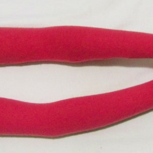 May include: A pair of long, bright pink arm warmers made of a soft, knitted fabric. The arm warmers are shown on a white background.