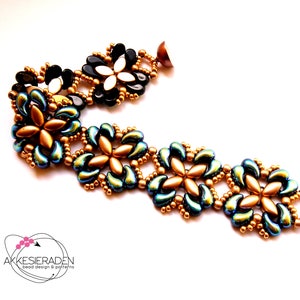 May include: A beaded bracelet with a gold and teal colour scheme. The bracelet features a repeating pattern of flower-shaped beads.