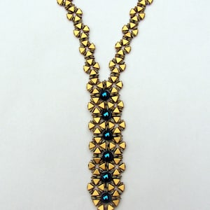 May include: A gold and blue beaded necklace with a geometric pattern. The necklace is made with small, triangular beads and larger, round beads.