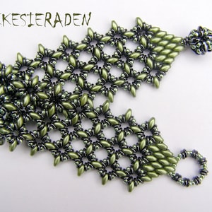 May include: A green and black beaded bracelet with a geometric pattern. The bracelet has a dangling charm at the end.
