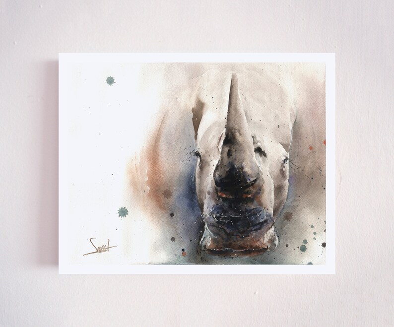 May include: A watercolor painting of a white rhinoceros with a brown and gray background. The rhinoceros is facing the viewer with its mouth closed. The painting has a light, airy feel.