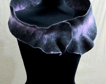 May include: A gray and purple felted wool scarf with a ruffled edge. The scarf is draped over a black mannequin.