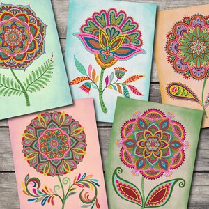 May include: Five colorful floral art prints. Each print features a unique, detailed flower design with vibrant colors like pink, teal, green, and orange. The flowers have intricate patterns and are set against textured backgrounds.