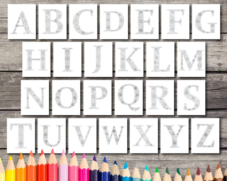 May include: A set of 26 alphabet letters, each letter is filled with a detailed intricate design. The letters are printed on white paper and are ready to be colored. The letters are arranged in alphabetical order. A set of colored pencils are in the foreground.