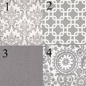May include: Four fabric swatches in gray and white. The first swatch has a damask pattern, the second has a geometric pattern, the third is a solid gray, and the fourth has a floral pattern.