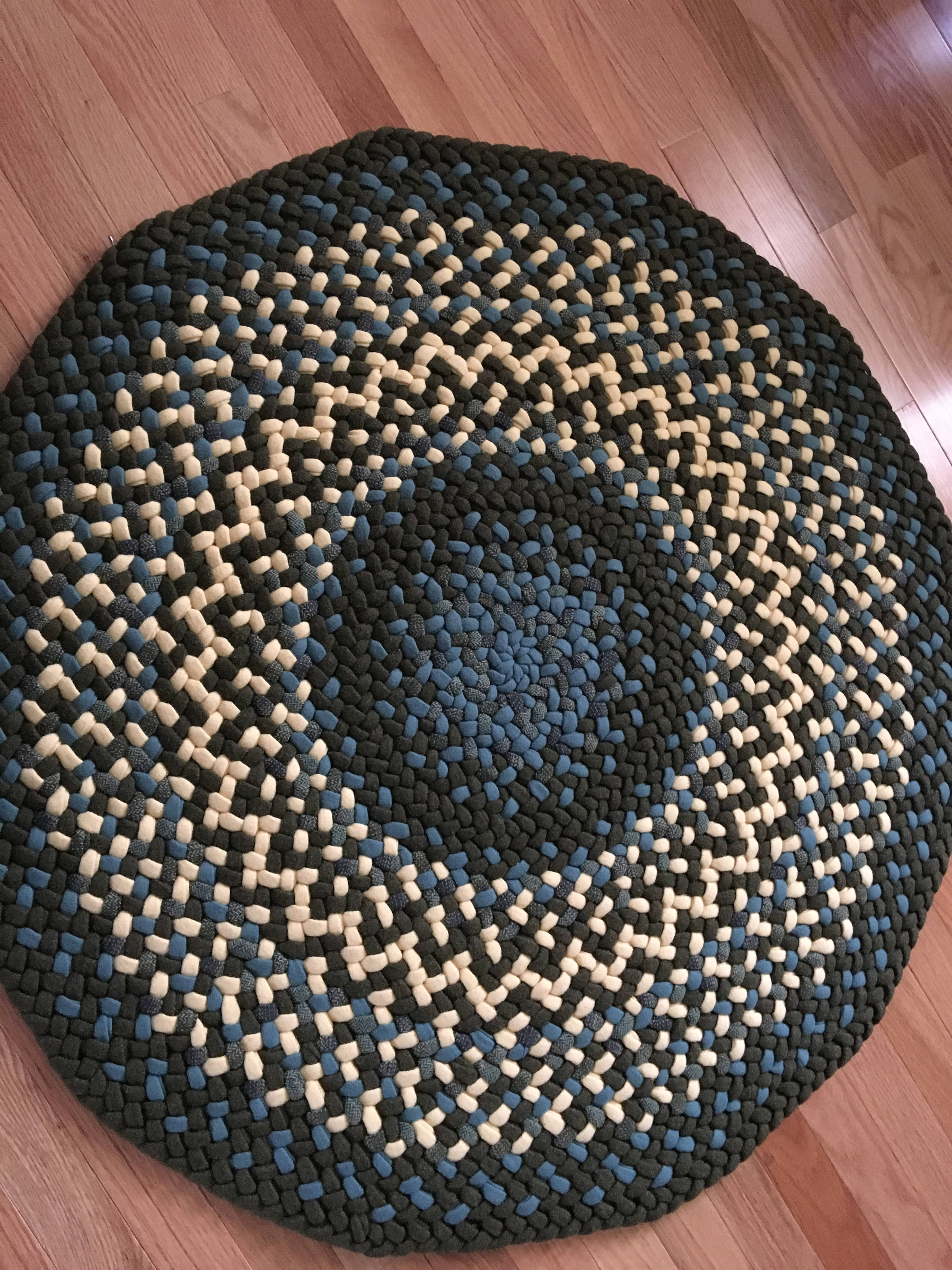 This is a round braided rug in light blue yellow and army Etsy