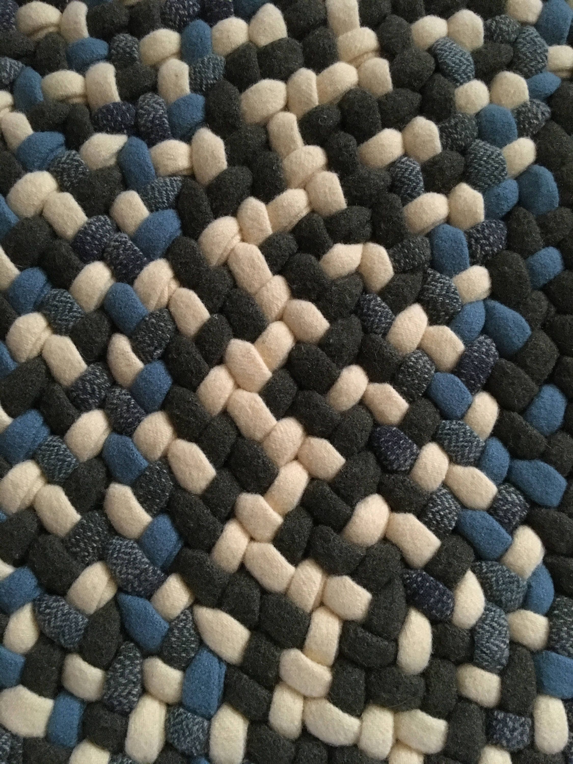 This is a round braided rug in light blue yellow and army Etsy