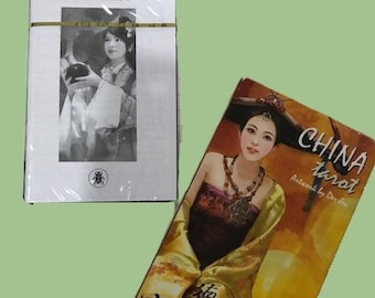 May include: A deck of China Tarot cards with a woman in traditional Chinese clothing on the front. The text on the box reads "China Tarot" and "Artwork by Der Sen".