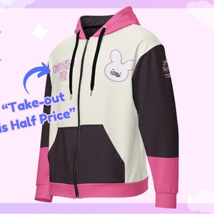 May include: A zip-up hoodie with a white front panel, black side panels, and pink accents on the hood and sleeves. The hoodie features a bunny graphic with a mustache and the text "Take-out is Half Price".