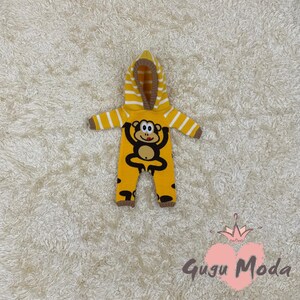 May include: Yellow knitted baby onesie with a monkey design and a brown striped hood.
