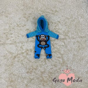 May include: Blue hooded baby onesie with a monkey graphic. The onesie has a striped pattern on the sleeves and legs.