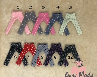 May include: Ten pairs of doll leggings with polka dot patterns in various colors, including pink, gray, red, black, and purple. The leggings are numbered 1 through 10.