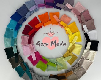 May include: A variety of colorful long-sleeved shirts arranged in a circle. The shirts are made of a soft, stretchy fabric and are perfect for layering or wearing on their own. The shirts are available in a variety of colors, including red, orange, yellow, green, blue, purple, and pink. The shirts are all the same size and are perfect for dolls or small children.