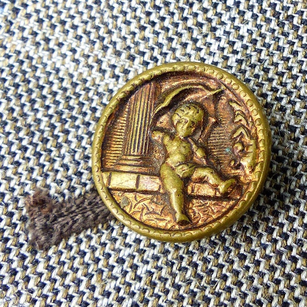 Circa 1900s antique cherub and greek column copper raised story button in bronze copper. Magnetic MagTAK lapel pin & tie tack