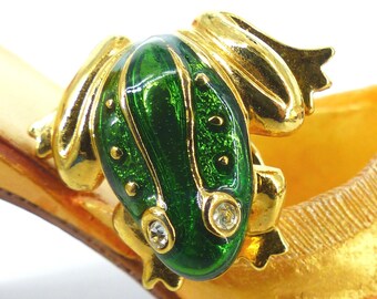 Sweet little crouched green enamel and gold frog with clear crystal eyes. Push pin back. Tie tack or lapel pin. Comes packaged as a gift.
