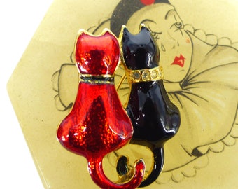 Sweetest little kitty couple. Red & black enamel cats with gold trim, tiny rhinestone collar detail. Vintage at it's best. Gift packaged