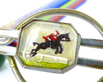 Amazing antique collector jockey jumping horse on the greens reverse painted under glass loop style tie bar.