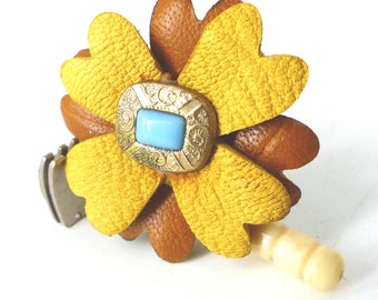 Upcycled antique brown and chamois magnetic leather flower with turquoise set in gold center. Silk covered back button. Gift packaged