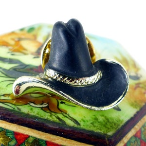 Cool little black western rodeo cowboy hat gold tie tack or lapel pin with rope band details. Pinch pin back. Free gift packaging.