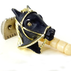 Cool little black and gold western horse head tie tack or lapel pin with rope halter details. Pinch pin back. Free gift packaging.