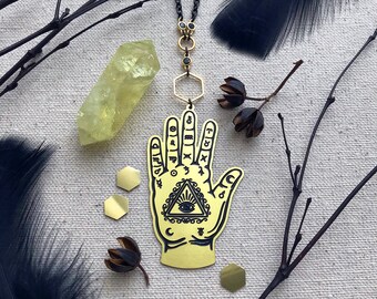 Gold & Black Necklace No.8 with hamsa hand, all seeing eye, astrology signs. Gold plated accent findings, 24" black stainless steel chain.