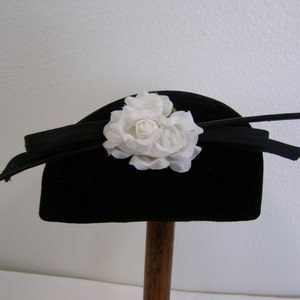 Vintage 1950's women's millinery hat. Black velvet or velour cocktail style with feather and silk flower. image 1