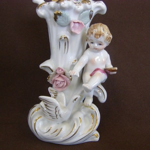 Vintage Porcelain baby bud vase with bird. Marked on bottom. Good condition, but has small chip and signs of being glued.