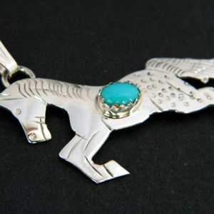 May include: Sterling silver pendant featuring a detailed horse design with a turquoise stone set in the center.