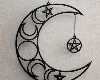 May include: Black metal crescent moon wall hanging with three smaller moons and a pentagram inside each moon. A smaller pentagram hangs from the top of the crescent moon.