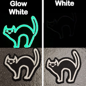 May include: A black cat silhouette patch with a white outline. The patch glows green in the dark. The text "Glow White" is above the patch. The text "White" is above a second black cat silhouette patch with a white outline.